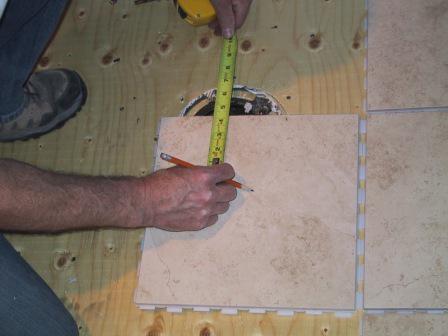 installation of a toilet bowl on a tile